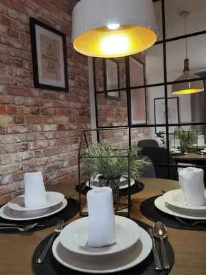 a dining room table with plates and napkins on it at Prestige Banja Luka in Banja Luka