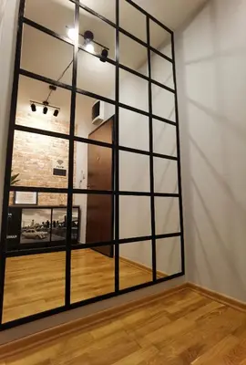 a large mirror in a room with a wooden floor at Prestige Banja Luka in Banja Luka