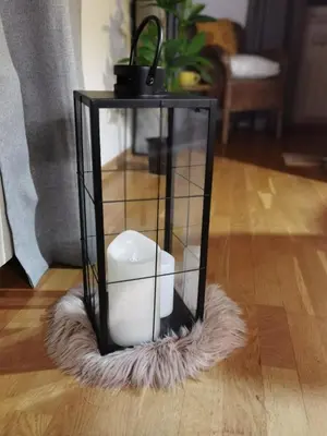 a glass cube with a candle in it on a furry floor at Prestige Banja Luka in Banja Luka