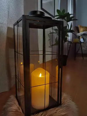 a candle in a glass box on a rug at Prestige Banja Luka in Banja Luka