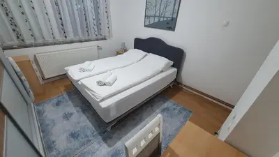 a small bedroom with a bed in a room at Apartman Dina in Bihać