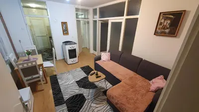 a living room with a couch and a rug at Apartman Dina in Bihać