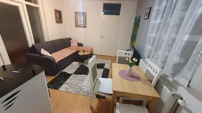 a small living room with a couch and a table at Apartman Dina in Bihać