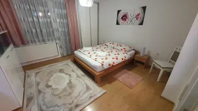 a small bedroom with a bed and a window at Apartman Dina in Bihać