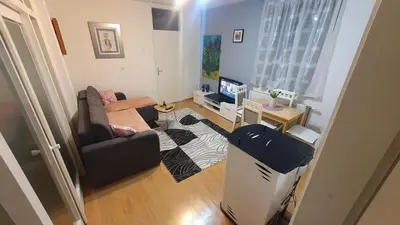 a living room with a couch and a television at Apartman Dina in Bihać