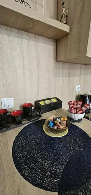 a kitchen counter with a plate of food on a table at Apartmani blue i green in Bugojno