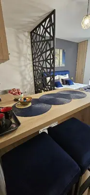 a room with a table with two beds at Apartmani blue i green in Bugojno