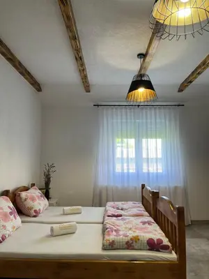 a bedroom with two beds and a window at Apartmani Subotic in Bosanska Gradiška