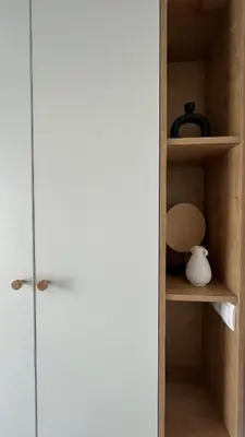 a closet with a white door and a vase on a shelf at Apartmani Subotic in Bosanska Gradiška