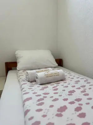 a bed with two pillows on top of it at Apartmani Subotic in Bosanska Gradiška