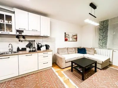 a kitchen and living room with a couch and a table at DAMI in Tuzla