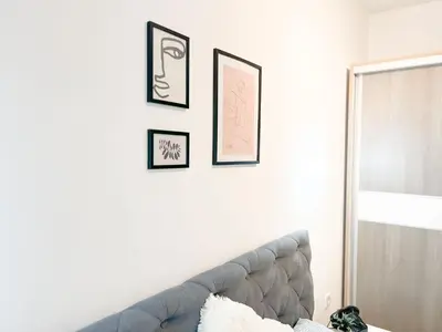 a living room with a couch and framed pictures on a wall at DAMI in Tuzla