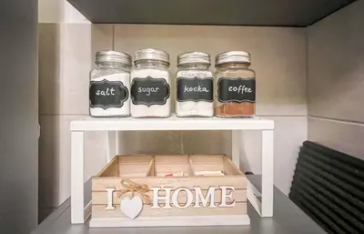 a shelf with three jars on it with a box at DAMI in Tuzla