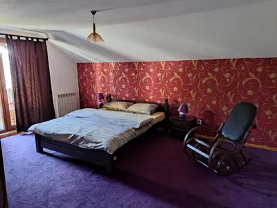 a bedroom with a bed and a chair in it at Apartman Stari Travnik in Travnik