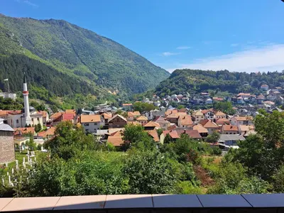 a town in a valley with mountains in the background at Apartman Stari Travnik in Travnik