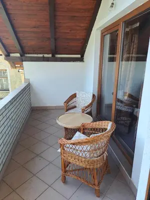 a porch with a table and chairs on a balcony at Apartman Stari Travnik in Travnik