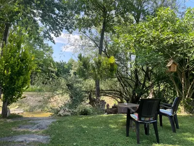 two chairs and a table in the grass at River house - Riječna idila in Cazin