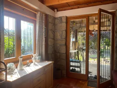 a kitchen with a french door and windows at River house - Riječna idila in Cazin