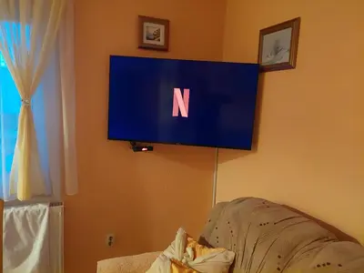 a television with the letter n on a wall at Apratmani Ivić in Kupres