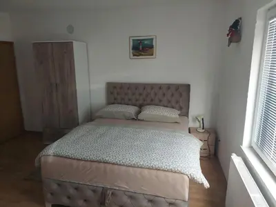 a bedroom with a large bed in a room at Apratmani Ivić in Kupres
