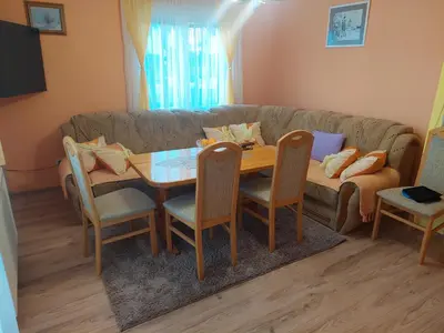 a living room with a table and a couch at Apratmani Ivić in Kupres