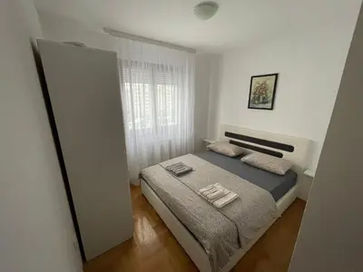 a bedroom with a bed with two towels on it at Apartman Lola in Banja Luka
