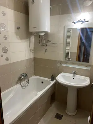 a bathroom with a sink and a bath tub and a sink at Apartman Lola in Banja Luka