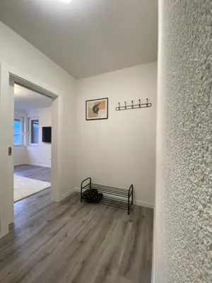 an empty living room with a bench on the wall at New World in Bihać