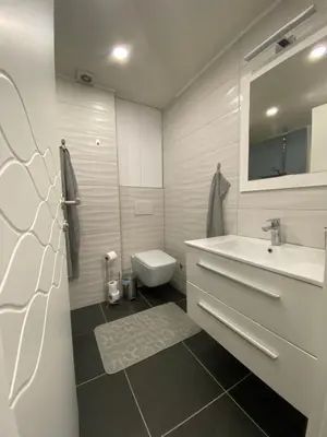 a white bathroom with a sink and a toilet at New World in Bihać