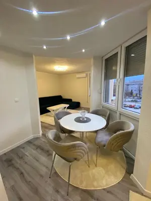 a dining room with a table and chairs at New World in Bihać