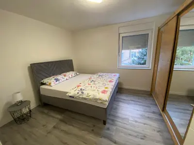 a small bedroom with a bed and a window at New World in Bihać