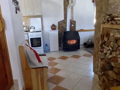 a living room with a stove and a fireplace at Montecasa in Travnik