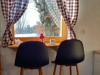 two chairs sitting at a table in front of a window at Montecasa in Travnik