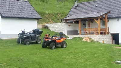 two motorcycles parked in the grass in front of a house at Kuća za odmor Ravančić in Sopot