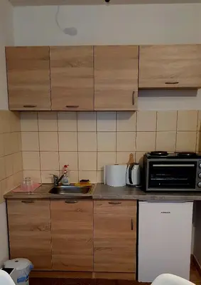 a kitchen with a microwave and a sink at Studio Apartman Maša Kupres in Kupres