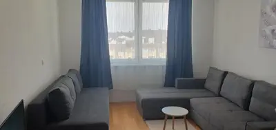 a living room with a couch and a window at Studio Apartman Maša Kupres in Kupres