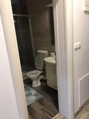 a bathroom with a toilet and a sink at Apartman Jaca in Tuzla