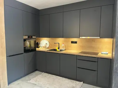 a kitchen with black cabinets and a sink and a microwave at Villa Nejra in Bihać