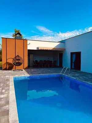 a large swimming pool in front of a house at Villa Nejra in Bihać