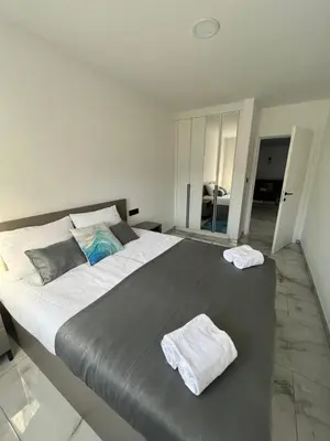 a bedroom with a large bed with two towels on it at Villa Nejra in Bihać