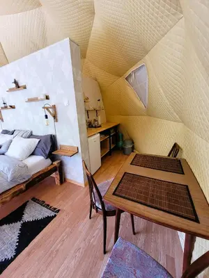 a room with a bed and a table in a room at Nomad Glamping in Šipovo