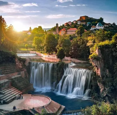 a view of a waterfall with people standing in front of it at Nomad Glamping in Šipovo