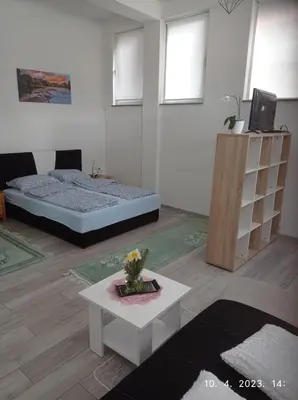 a living room with a bed and a table at Studio apartman Sokak in Bihać