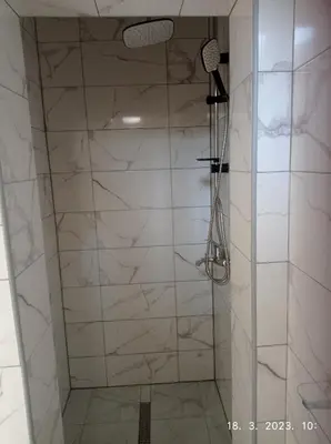 a shower with a glass door in a bathroom at Studio apartman Sokak in Bihać