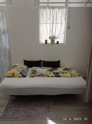 a bed sitting in a bedroom with a window at Studio apartman Sokak in Bihać