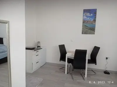 a room with a table and chairs and a bed at Studio apartman Sokak in Bihać
