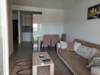 a living room with a couch and a table at HELA Lux apartment in Modriča