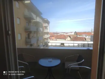 a room with a table and chairs and a window at HELA Lux apartment in Modriča