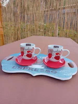 two coffee cups sitting on a tray on a table at AURORA in Visoko