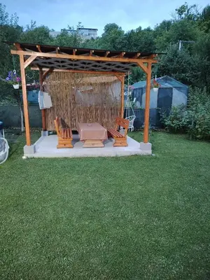 a gazebo with chairs and a couch in a yard at AURORA in Visoko
